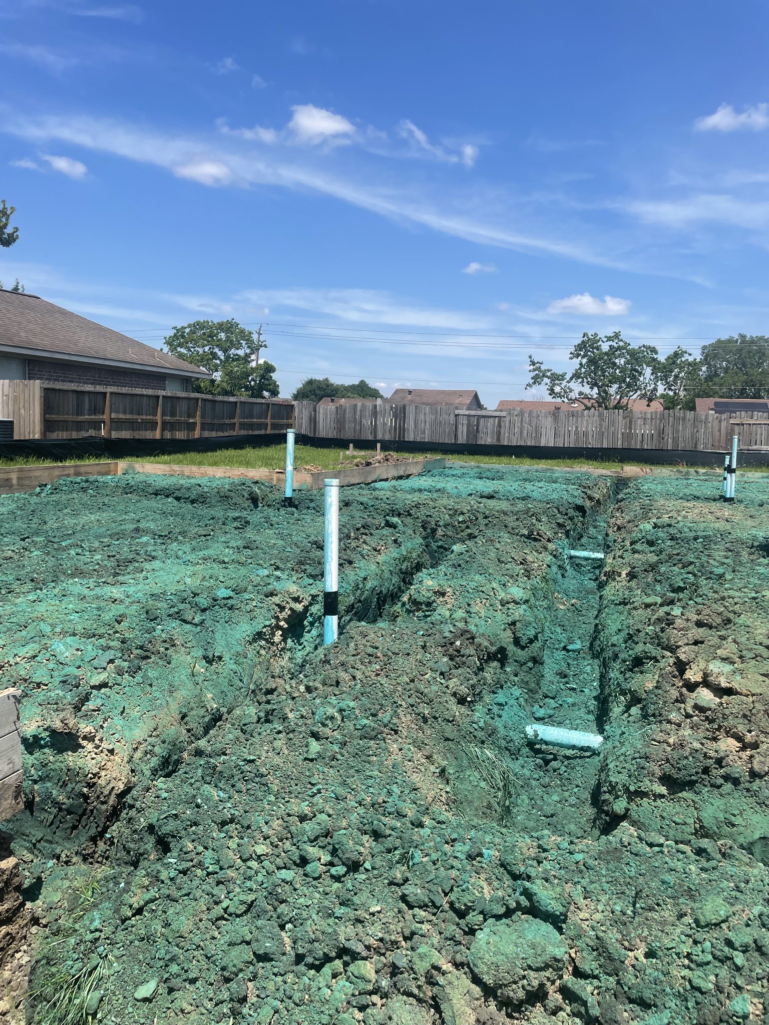 Prepared new-construction soil and plumbing before a concrete slab is poured